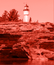 rocky cliff with trees and lighthouse