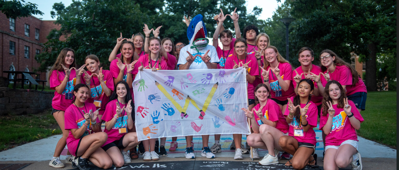Students posing together at an outdoor event.