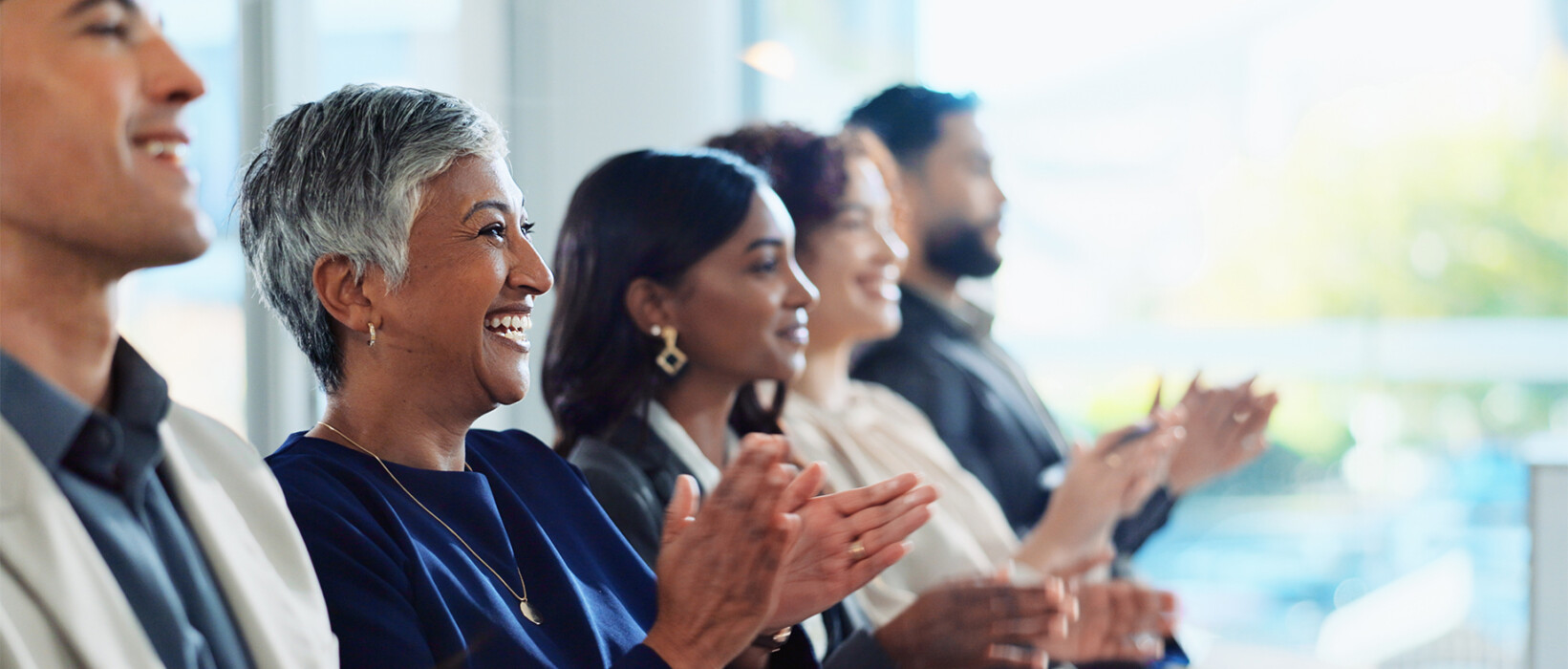 Professionals applauding during a workshop or training event.