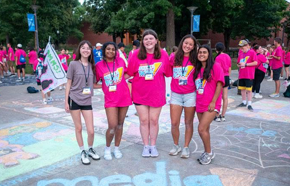 Students standing together at an outdoor event.