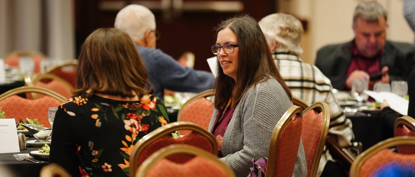 Iowa newspaper professionals talking during an annual convention meal.