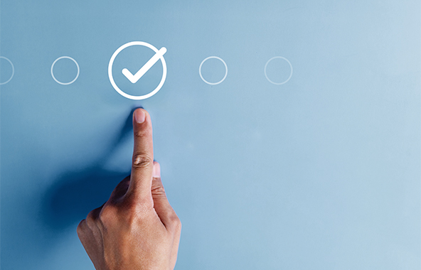 Finger selecting a checkmark option on a digital screen.