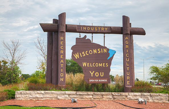Wisconsin welcome sign highlighting recreation, industry and agriculture.