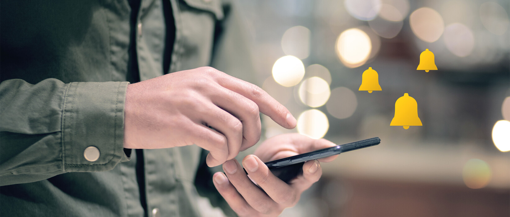 Person using a smartphone with notification icons.